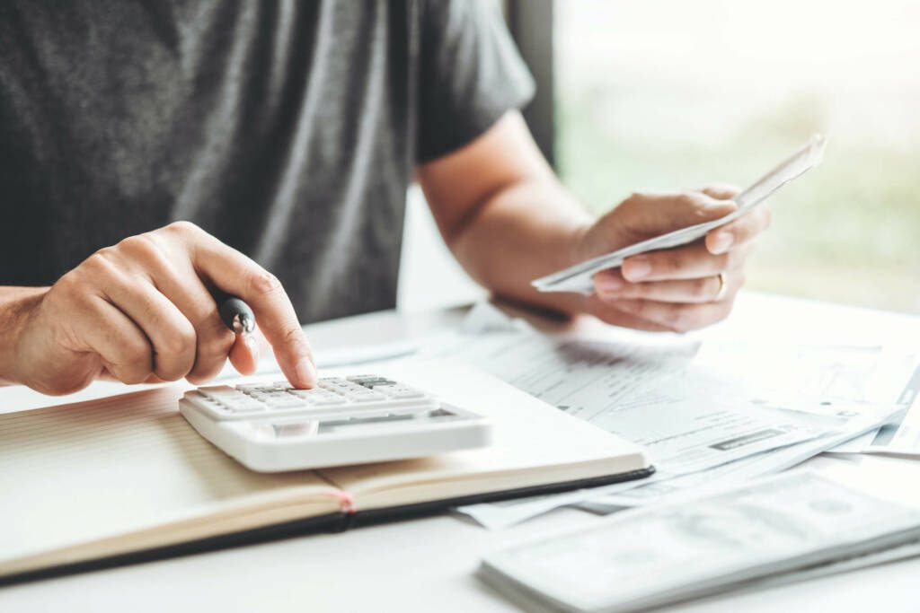 Person reviewing statements and bills for business cash management