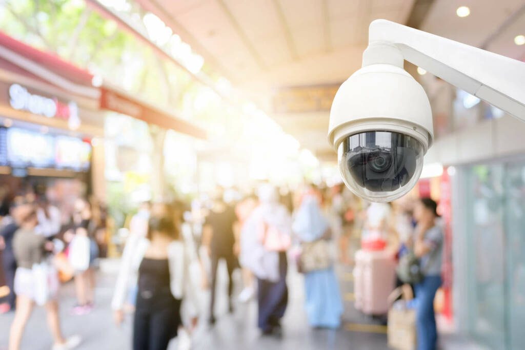 High-level view of a security camera at a shopping center with people walking in the background.
