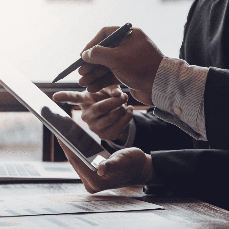 two people viewing bank statements on a tablet