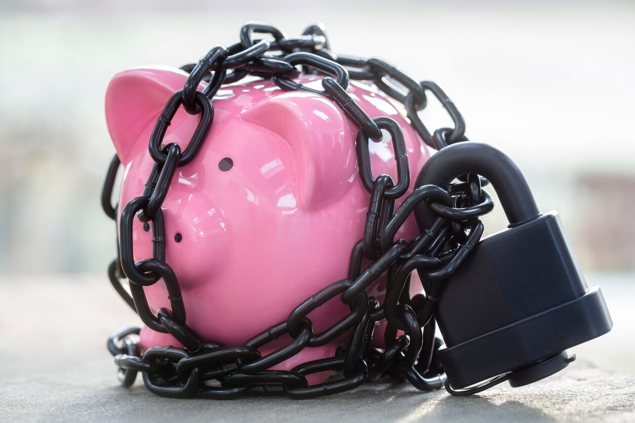 a piggy bank with a chain lock representing debanking