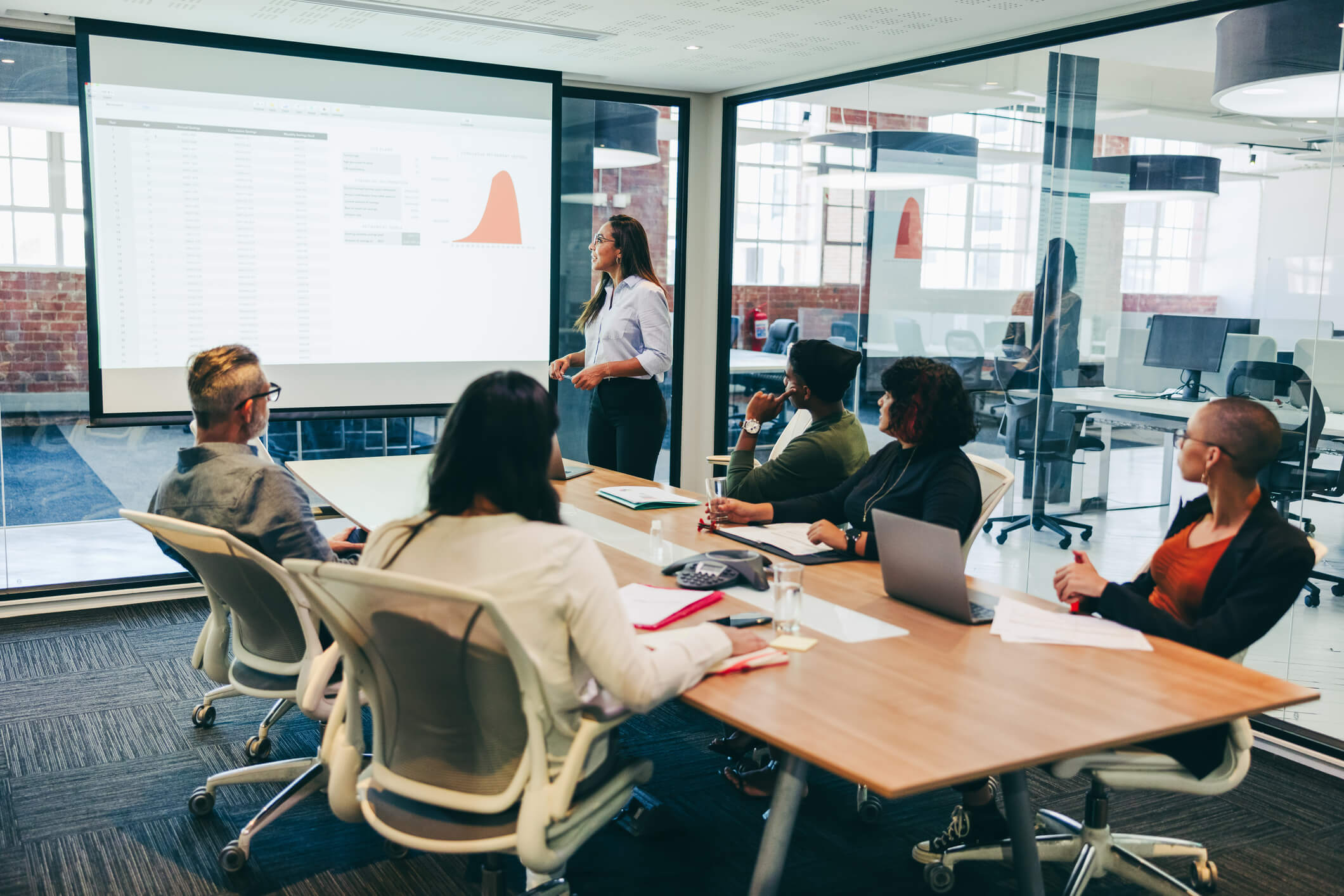 a group holding an in person meeting in an office room