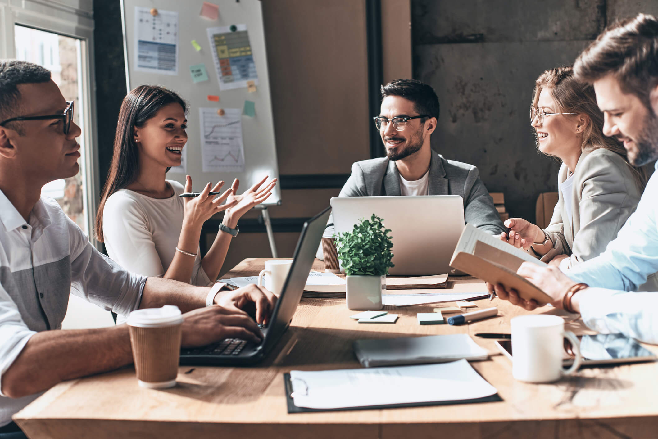 a group speaking enthusiastically at a meeting