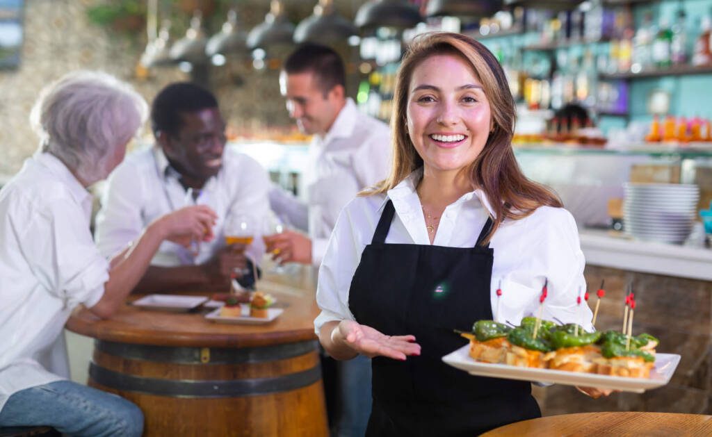 a restaurant server who is delivering a great experience