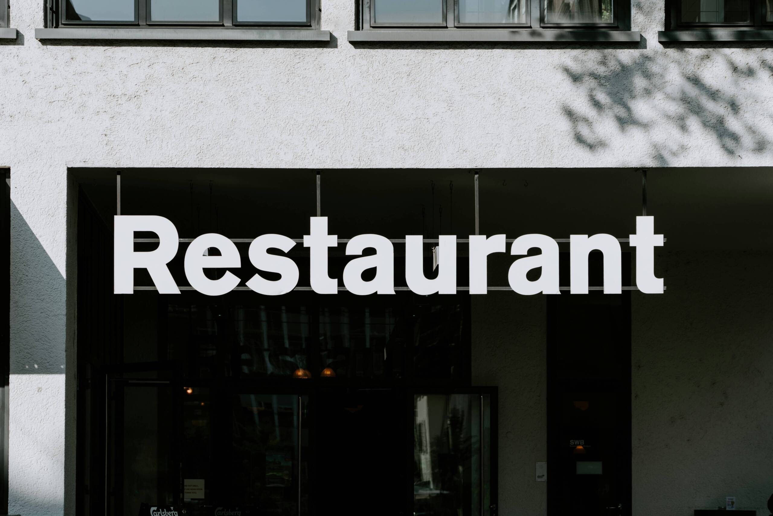 a black and white restaurant sign for a franchised location
